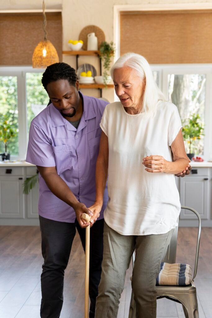 This is an image of a carer helping an elderly woman to walk.