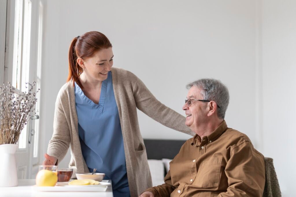 This is an image of a carer talking to an elderly man.